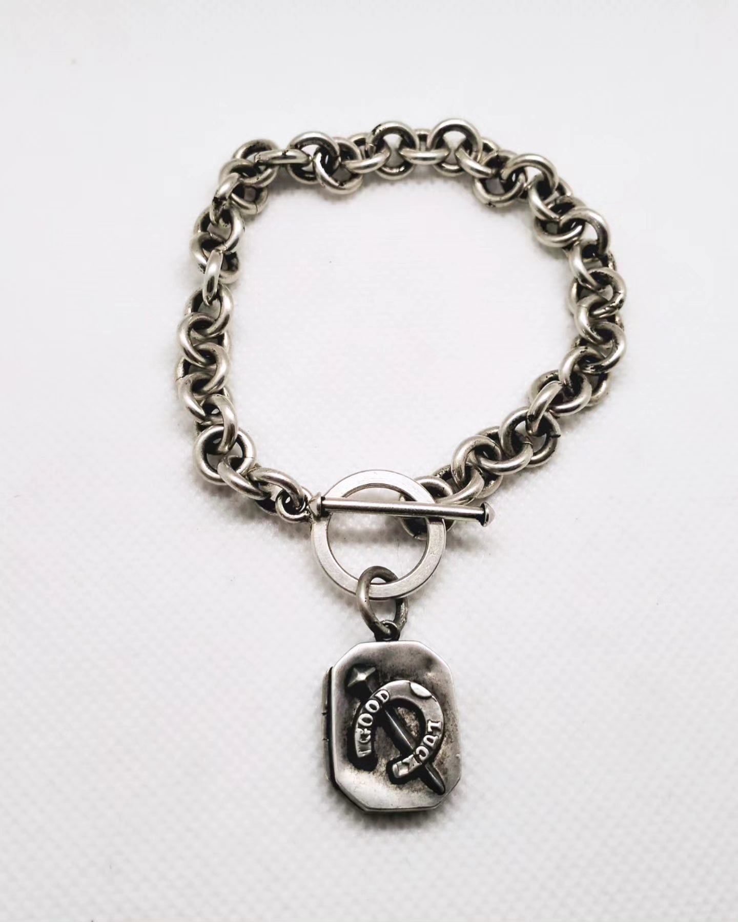 Victorian Good luck locket attached to a Modern estate sterling silver bracelet