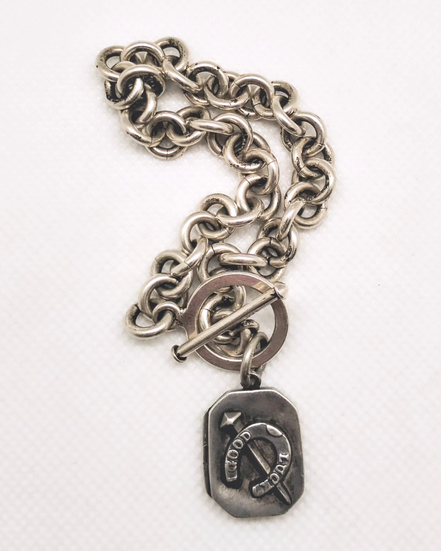 Victorian Good luck locket attached to a Modern estate sterling silver bracelet